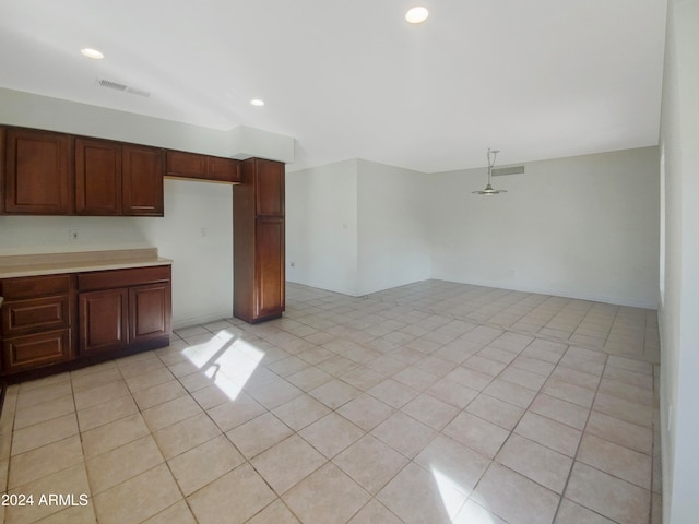 kitchen with light tile patterned floors and decorative light fixtures