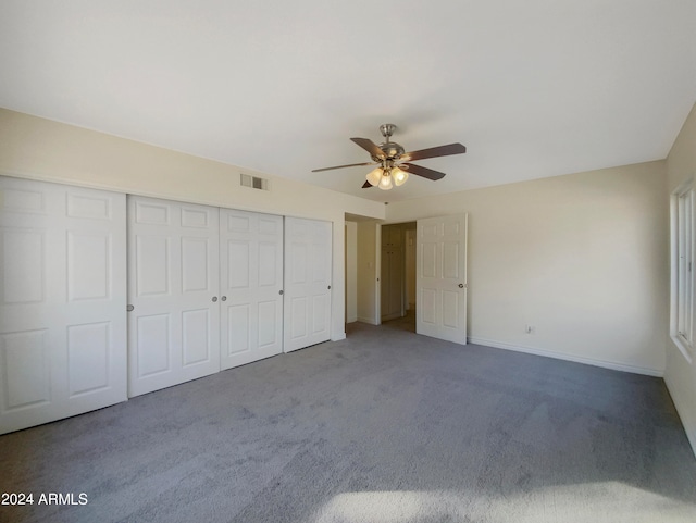 unfurnished bedroom featuring a closet, carpet, and ceiling fan