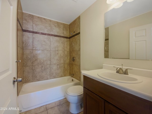 full bathroom with toilet, tiled shower / bath, vanity, and tile patterned floors