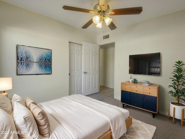 carpeted bedroom featuring a closet and ceiling fan