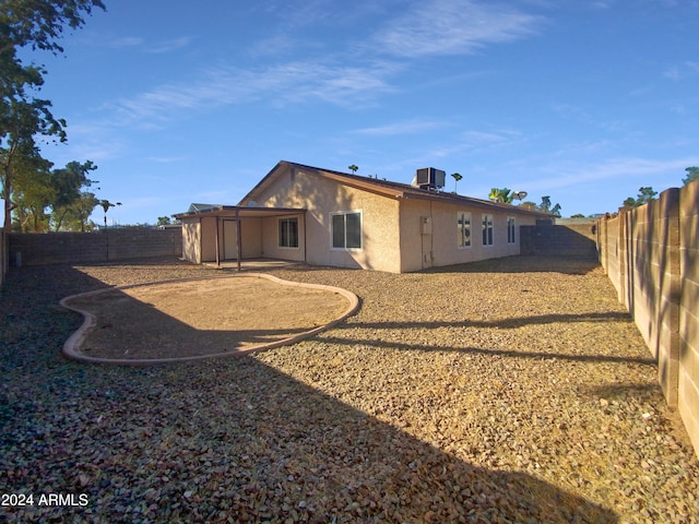 rear view of property featuring central air condition unit