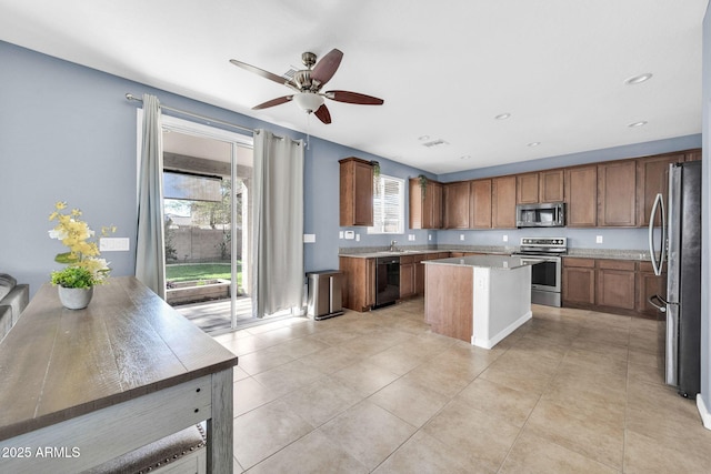 kitchen featuring sink, a wealth of natural light, a center island, and stainless steel appliances