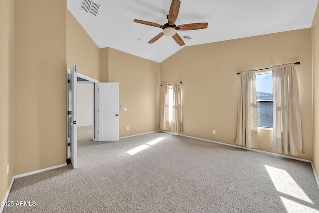 carpeted spare room featuring vaulted ceiling and ceiling fan