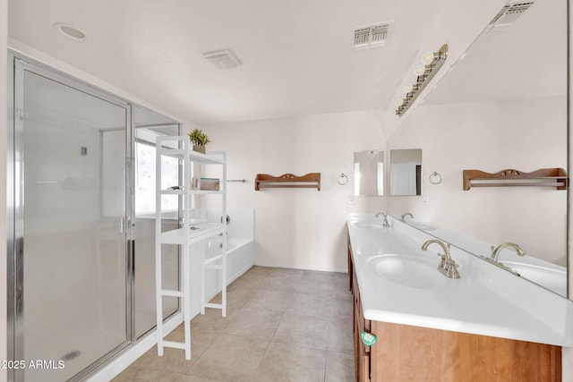 bathroom featuring tile patterned flooring, shower with separate bathtub, and vanity