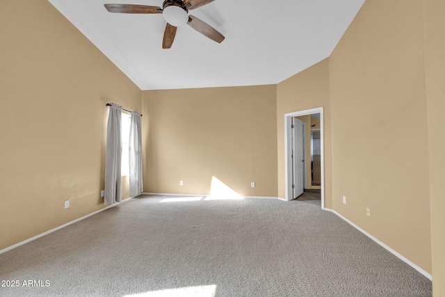 carpeted spare room featuring ceiling fan and high vaulted ceiling