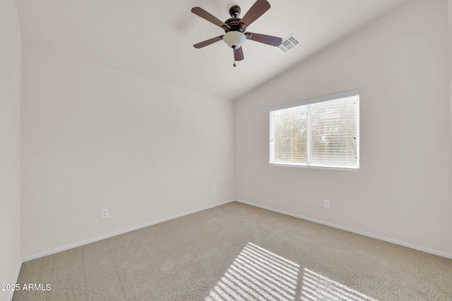 carpeted spare room featuring ceiling fan and lofted ceiling