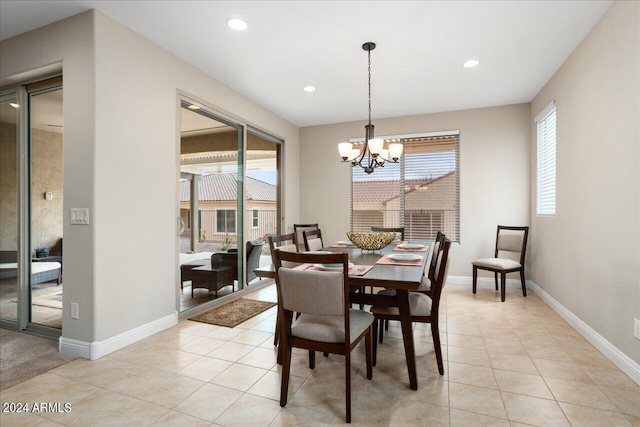 tiled dining space with an inviting chandelier and a wealth of natural light