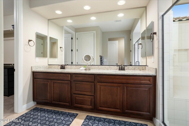 bathroom with an enclosed shower and dual vanity