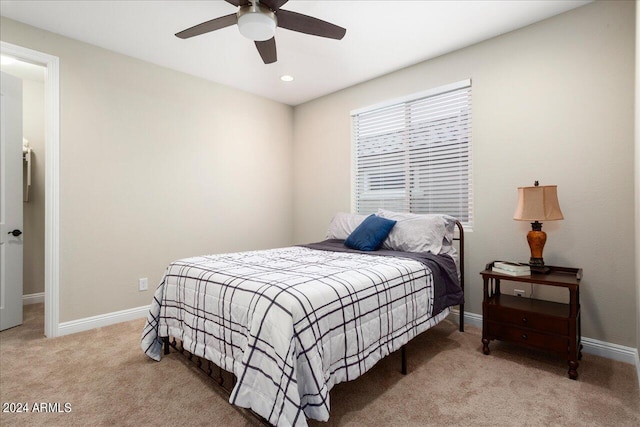 bedroom featuring light colored carpet and ceiling fan