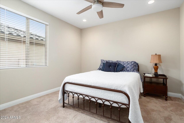 bedroom featuring light colored carpet and ceiling fan