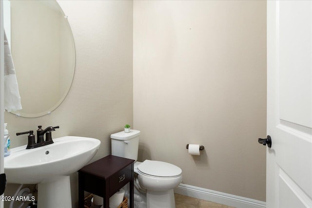 bathroom with toilet and tile flooring