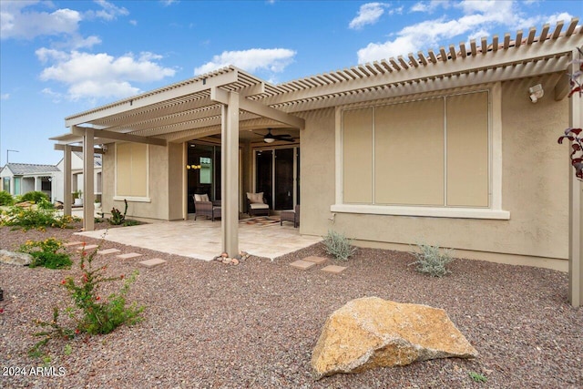 rear view of house featuring a pergola and a patio