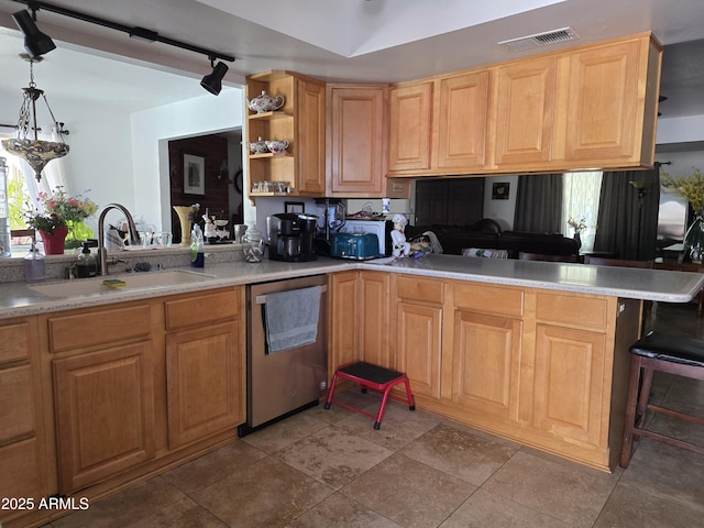 kitchen featuring open shelves, a sink, dishwasher, a peninsula, and visible vents