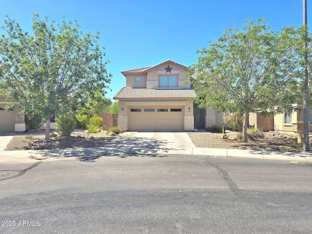 44583 W Sandstone Dr, Maricopa, AZ 85139 - view of front facade featuring stucco siding, a tiled roof, concrete driveway, and a garage