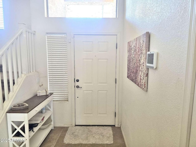 44583 W Sandstone Dr, Maricopa, AZ 85139 - foyer featuring dark tile patterned floors and a high ceiling