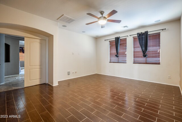 spare room with ceiling fan and dark hardwood / wood-style floors