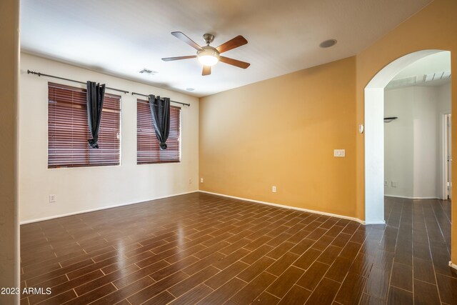 empty room featuring ceiling fan and dark hardwood / wood-style flooring