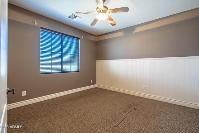 unfurnished room with ceiling fan and carpet flooring