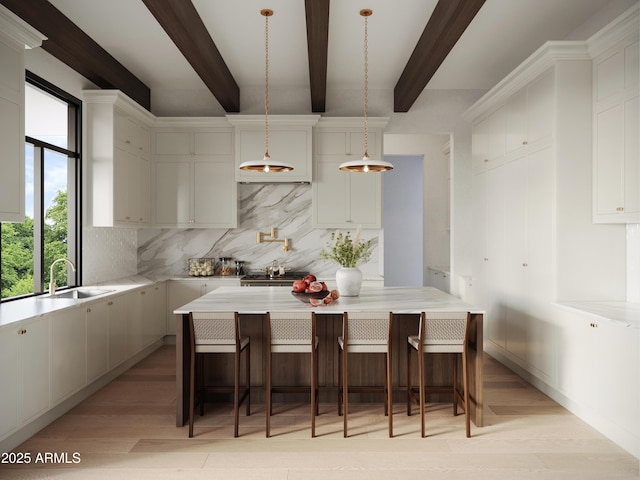 kitchen with hanging light fixtures, a center island, light hardwood / wood-style floors, tasteful backsplash, and a breakfast bar area