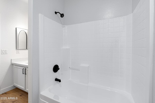 bathroom featuring bathtub / shower combination, hardwood / wood-style floors, and vanity