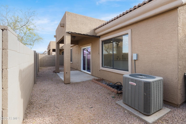 back of house with central AC and a patio