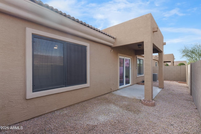 exterior space with central AC unit and a patio area