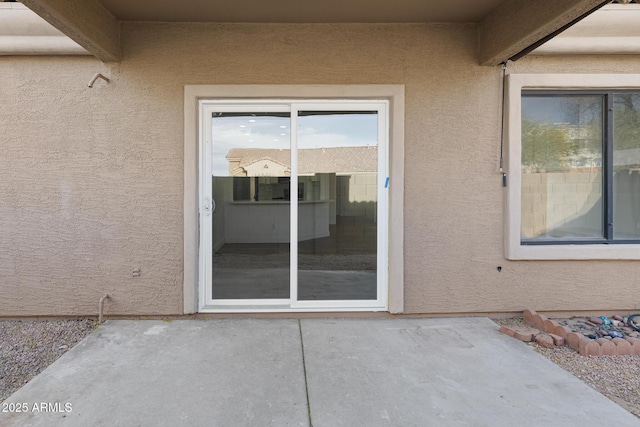 entrance to property featuring a patio area