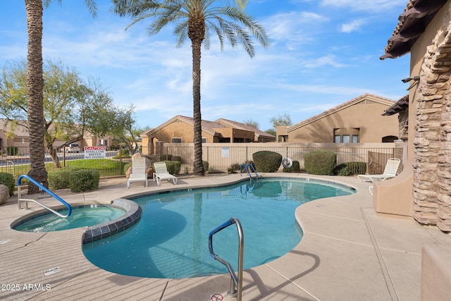 view of swimming pool with a hot tub and a patio