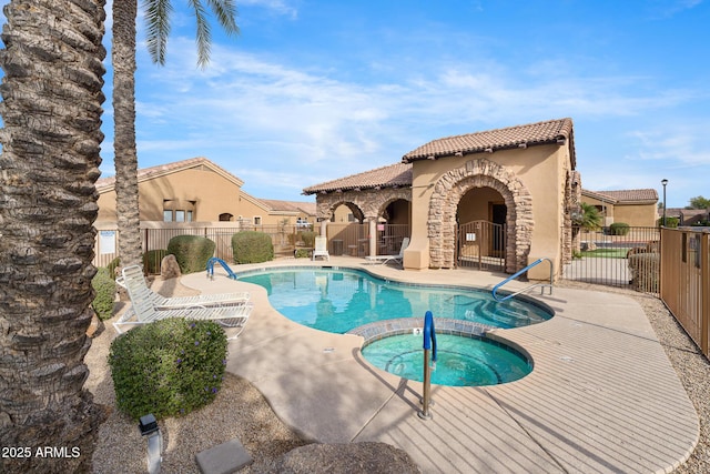 view of pool with a patio area and a hot tub