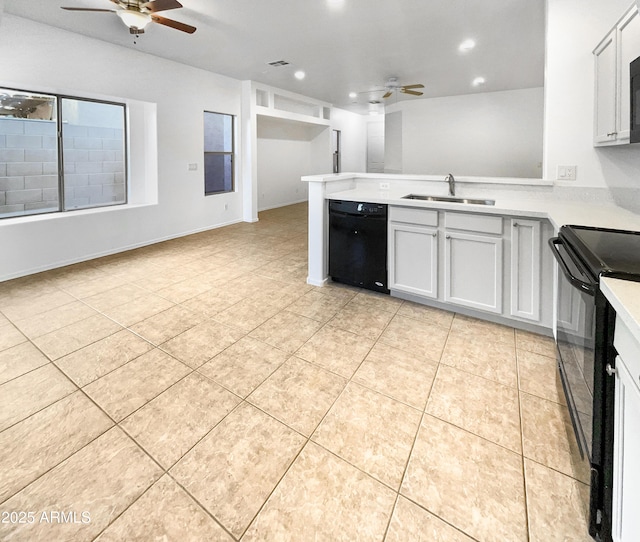 kitchen with sink, white cabinets, black appliances, and light tile patterned floors