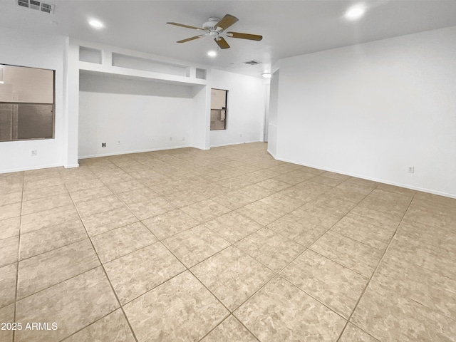 unfurnished living room with ceiling fan and light tile patterned flooring