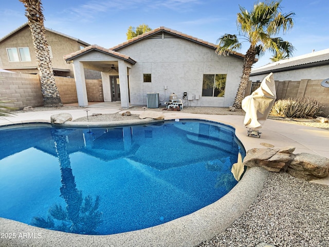 view of pool featuring a patio and central AC