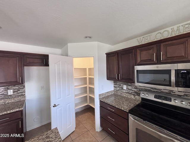 18629 W Fulton St, Goodyear, AZ 85338 - kitchen featuring appliances with stainless steel finishes, tasteful backsplash, light tile patterned flooring, and dark brown cabinets
