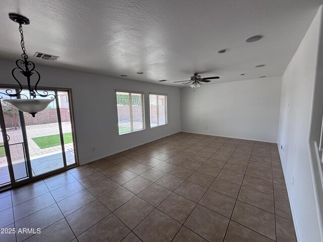 18629 W Fulton St, Goodyear, AZ 85338 - spare room featuring dark tile patterned floors, ceiling fan, and baseboards