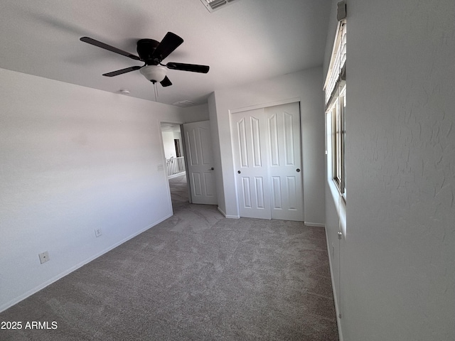 18629 W Fulton St, Goodyear, AZ 85338 - unfurnished bedroom featuring carpet, a closet, baseboards, and a ceiling fan