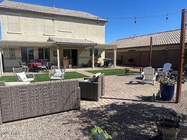18629 W Fulton St, Goodyear, AZ 85338 - back of property with a patio area, fence, a tiled roof, outdoor lounge area, and stucco siding
