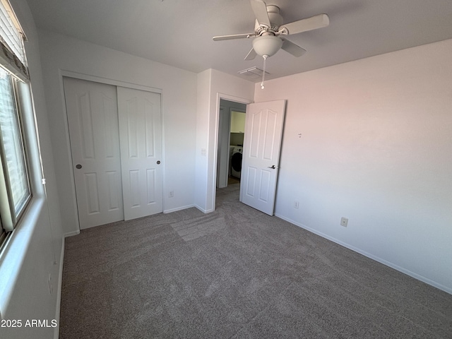 18629 W Fulton St, Goodyear, AZ 85338 - unfurnished bedroom with carpet flooring, washer / clothes dryer, a closet, baseboards, and multiple windows