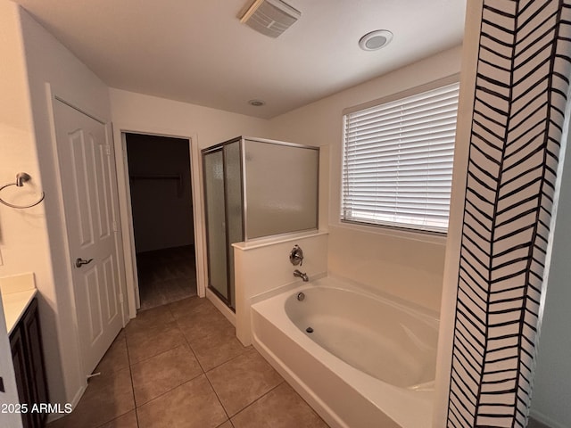 18629 W Fulton St, Goodyear, AZ 85338 - full bathroom with a stall shower, tile patterned flooring, a garden tub, vanity, and a spacious closet