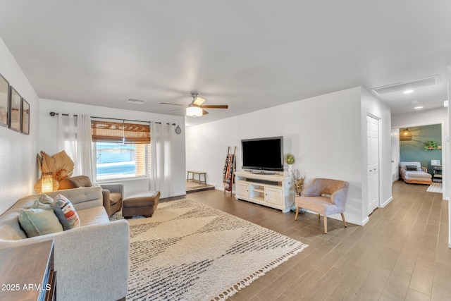 living room featuring wood-type flooring and ceiling fan