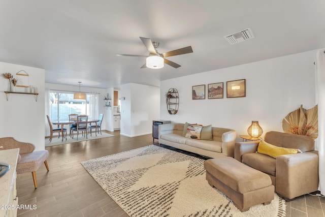 living room featuring hardwood / wood-style flooring and ceiling fan