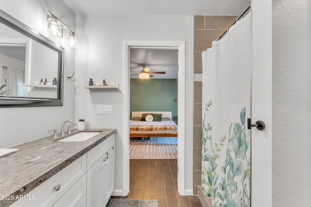 bathroom with vanity, ceiling fan, and a shower with shower curtain