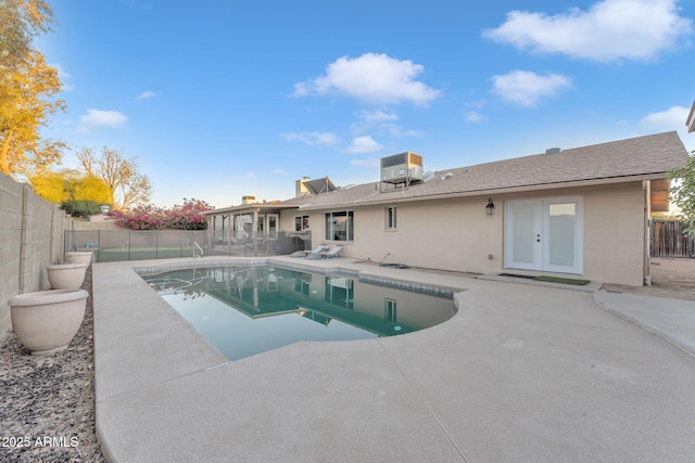 view of pool featuring cooling unit, a patio, and french doors