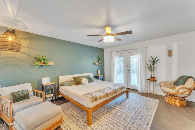 bedroom with hardwood / wood-style floors, access to outside, ceiling fan, and french doors