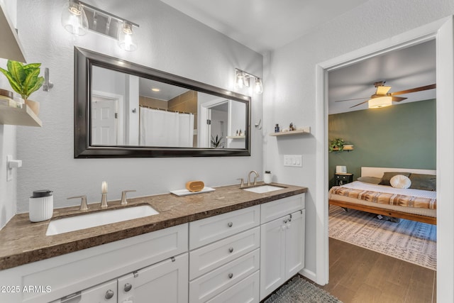 bathroom featuring vanity, wood-type flooring, ceiling fan, and a shower with shower curtain