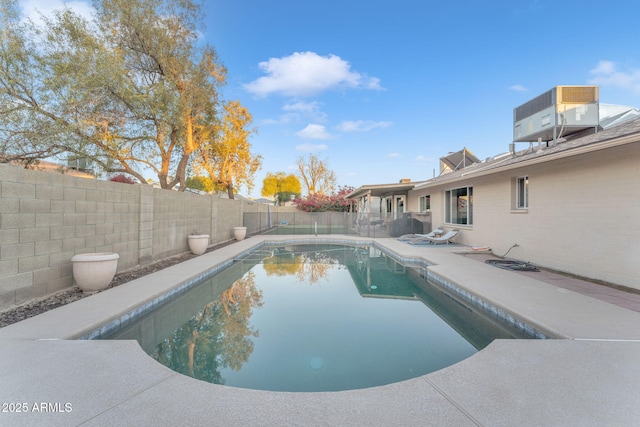 view of pool featuring a patio and central air condition unit