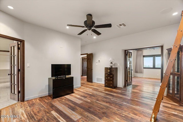 unfurnished living room with recessed lighting, wood finished floors, visible vents, and baseboards