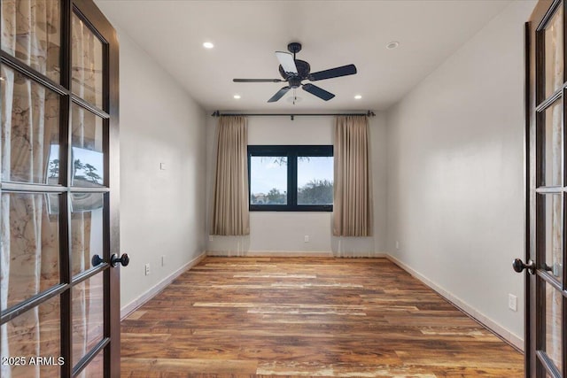 unfurnished room with recessed lighting, french doors, baseboards, and wood finished floors