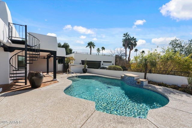 view of swimming pool featuring stairway, a fenced in pool, a fenced backyard, and a patio area