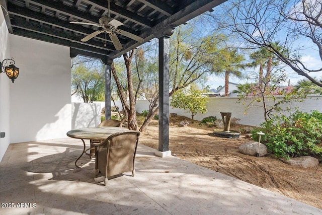 view of patio with a ceiling fan and fence