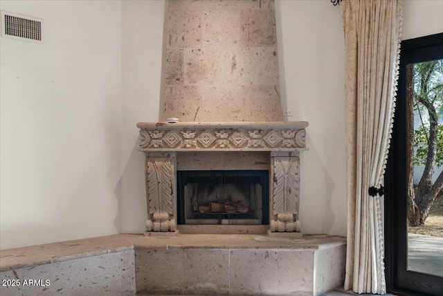 room details with a fireplace and visible vents